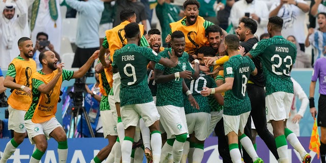 Salem Al-Dawsari of Saudi Arabia is congratulated after scoring his team's second goal during the World Cup group C soccer match between Argentina and Saudi Arabia at the Lusail Stadium in Lusail, Qatar, Tuesday, November 22, 2022. 