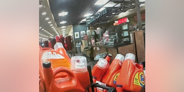 An officer noticed the suspect running out of the store with a grocery cart full of laundry detergent and took him into custody.
