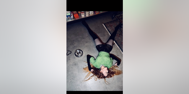 Madonna is seen sprawled out on the ground next to the dog bowl in her latest tricks, pretending to "play dead."