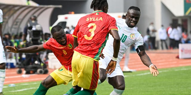 Senegal forward Sadio Mané to possibly miss entire World Cup due to leg injury Guinea's midfielder Naby Keita (8) and Guinea's defender Issiaga Sylla (3) fight for the ball with Senegal forward Sadio Mané (10) during a Group B Africa Cup of Nations 2021 soccer match at Stade de Kouekong in Bafoussam Jan. 14, 2022.
