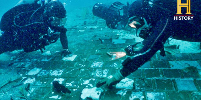 Underwater explorer and marine biologist Mike Barnette and wreck diver Jimmy Gadomski exploring a twenty-foot segment of the 1986 Space Shuttle Challenger, the team discovered in the waters off the coast of Florida during the filming of The History Channel.