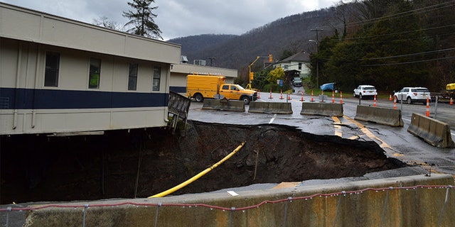 Officials said the initial sinkhole was six feet wide and 30 feet deep. 