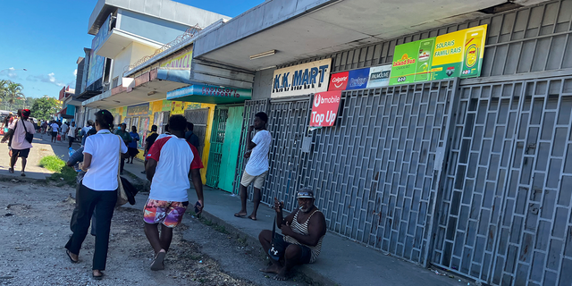 People gather outside closed shops in Honiara, Solomon Islands following an earthquake on Tuesday Nov 22, 2022.