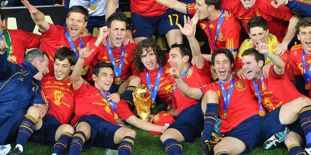 Spain players pose with the trophy following the 2010 FIFA football World Cup between the Netherlands and Spain on July 11, 2010, at Soccer City stadium in Soweto, Johannesburg.