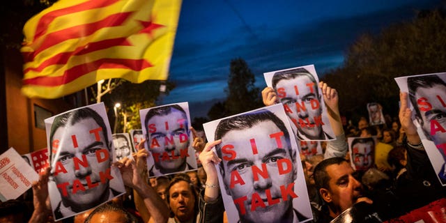 Catalonia pro-Independence demonstrators hold photos of Prime Minister and Socialist leader Pedro Sánchez, as they wait for his arrival outside a campaigning meeting in Viladecans, near Barcelona, Spain, on Oct. 30, 2019.