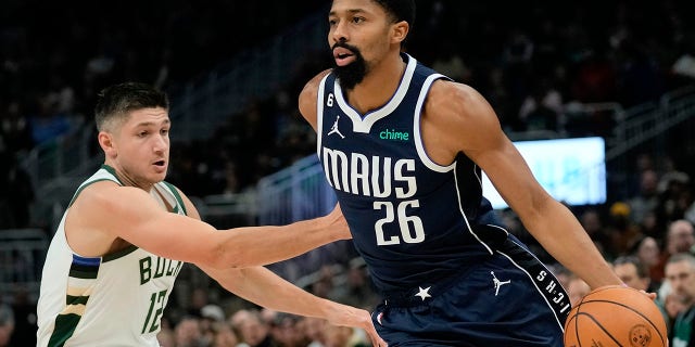 Dallas Mavericks' Spencer Dinwiddie, right, beats Milwaukee Bucks' Grayson Allen during the first half of an NBA basketball game Sunday, Nov. 27, 2022, in Milwaukee. 