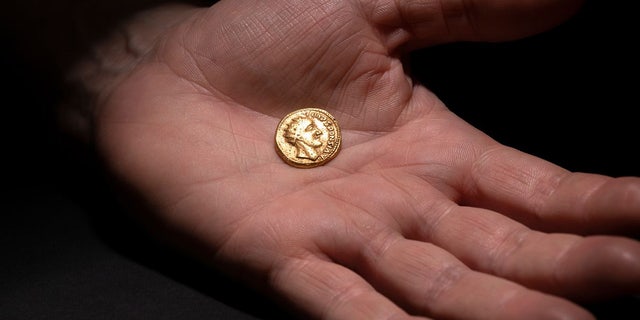The Sponsian coin is about the size of a quarter, though thicker and heavier.
