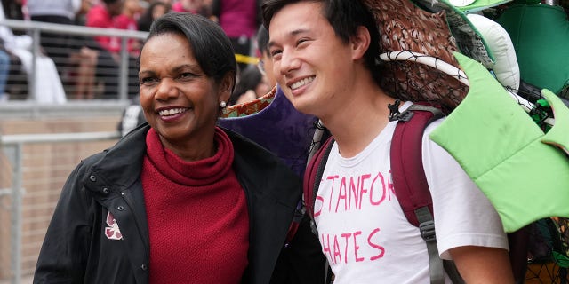 Nov 5, 2022; Stanford, California, USA; Former secretary of state Condoleezza Rice poses for a photo with the Stanford Cardinal tree mascot during the second quarter against the Washington State Cougars at Stanford Stadium.