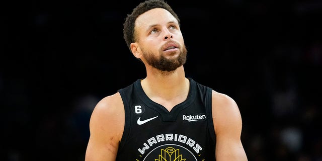 Golden State Warriors guard Stephen Curry, #30, looks at the scoreboard during the second half of an NBA basketball game against the Phoenix Suns, Wednesday, Nov. 16, 2022, in Phoenix. 