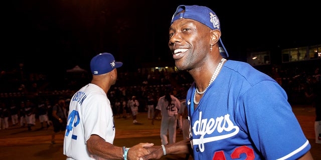 Terrell Owens celebrates the end of a game on the field at the Bumpboxx Honors 75th Anniversary Of Jackie Robinson Breaking The Color Barrier With Celebrity Softball Game At Jackie Robinson Field at Jackie Robinson Stadium on July 17, 2022 in Los Angeles, California.