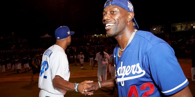 Terrell Owens celebrates the end of a game on the field at the Bumpboxx Honors 75th Anniversary Of Jackie Robinson Breaking The Color Barrier With Celebrity Softball Game At Jackie Robinson Field at Jackie Robinson Stadium on July 17, 2022 in Los Angeles, California.