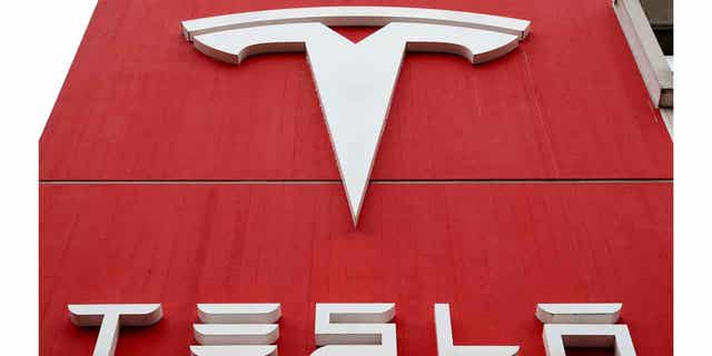 The logo of car manufacturer Tesla is seen at a branch office in Bern, Switzerland, October 28, 2020. 