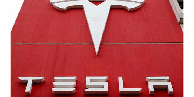 The logo of car manufacturer Tesla is seen at a branch office in Bern, Switzerland, October 28, 2020. 