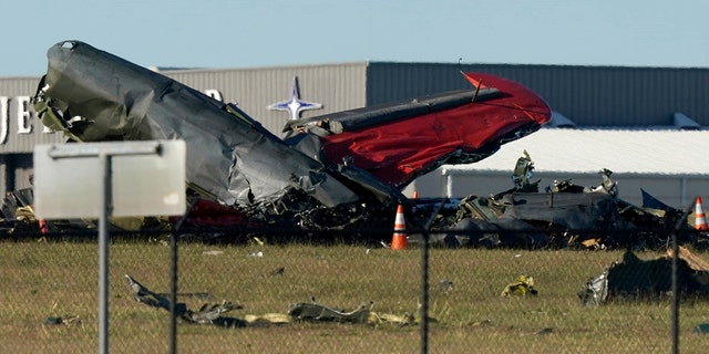 Debris from two planes that crashed during an airshow at Dallas Executive Airport lie on the ground Saturday, Nov. 12, 2022.