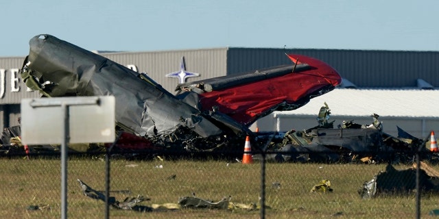 Debris from two planes that crashed during an airshow at Dallas Executive Airport lie on the ground Saturday, Nov. 12, 2022.