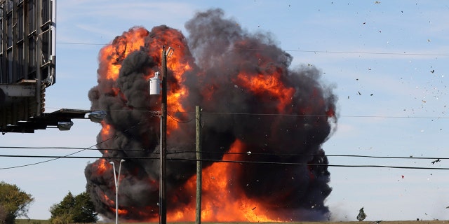 In this photo provided by Nathaniel Ross Photography, a historic military plane crashes after colliding with another plane during an airshow at Dallas Executive Airport in Dallas on Saturday, Nov. 12, 2022.