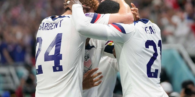 Tim Weah and his U.S. teammates celebrate after scoring during the World Cup against Wales at the Ahmad Bin Ali Stadium in Doha, Qatar, Monday, Nov. 21, 2022.