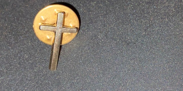 Timms wears the cross pin not only as a symbol of his Christian faith, but also in memory of his late wife.