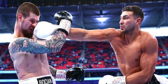 Daniel Bocianski, left, and Tommy Fury, right, exchange punches during their light heavyweight fight at Wembley Stadium on April 23, 2022 in London.