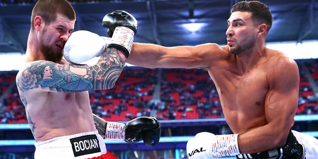 Daniel Bocianski, left, and Tommy Fury, right, exchange punches during their light heavyweight fight at Wembley Stadium on April 23, 2022 in London.