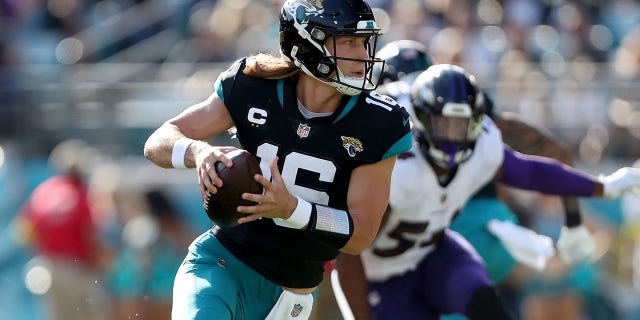 Trevor Lawrence #16 of the Jacksonville Jaguars fights during the first half of the game against the Baltimore Ravens at TIAA Bank Field on November 27, 2022 in Jacksonville, Florida.