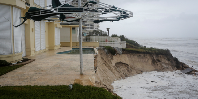 Waves crash into a beachfront house after Hurricane Nicole made landfall on Florida's east coast, in Daytona Beach Shores.