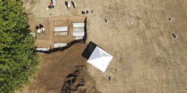 Crews search for bodies from the 1921 Tulsa Race Massacre at the Oaklawn Cemetery in Tulsa, Oklahoma, on Oct. 27, 2022. A team of scientists started the process of re-exhuming human remains Wednesday in their effort to identify victims killed in the massacre.