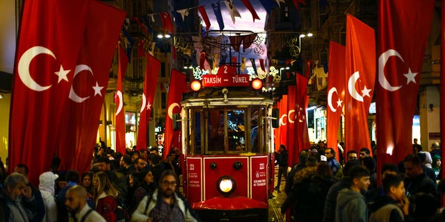 A tram rides past the spot of Sunday's explosion on Istanbul's popular pedestrian Istiklal Avenue in Istanbul, Turkey, on Nov. 14, 2022.