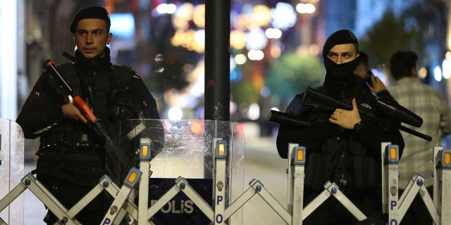 Police officers stand at the entrance the street after an explosion on Istanbul's popular pedestrian Istiklal Avenue, on Nov. 13, 2022.