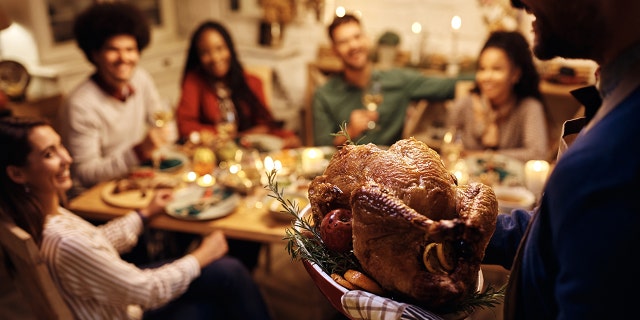 man offering thanksgiving turkey