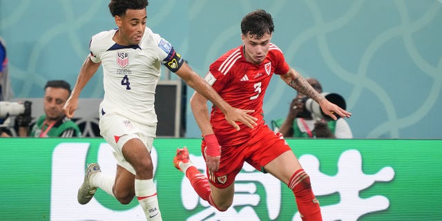 Tyler Adams (4) of the United States chases down a loose ball during a FIFA World Cup Qatar 2022 Group B match between Wales and USMNT at Ahmad Bin Ali Stadium on November 21, 2022, in Doha, Qatar.