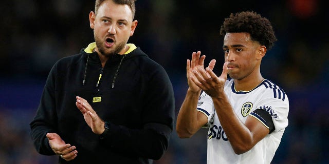 Leeds United's assistant manager Rene Maric and Tyler Adams applaud fans after the match.