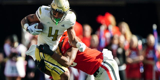 Georgia Tech running back Dontae Smith (4) is stopped by Georgia linebacker Jamon Dumas-Johnson (10) during the first half of an NCAA college football game Saturday, Nov. 26, 2022 in Athens, Ga.