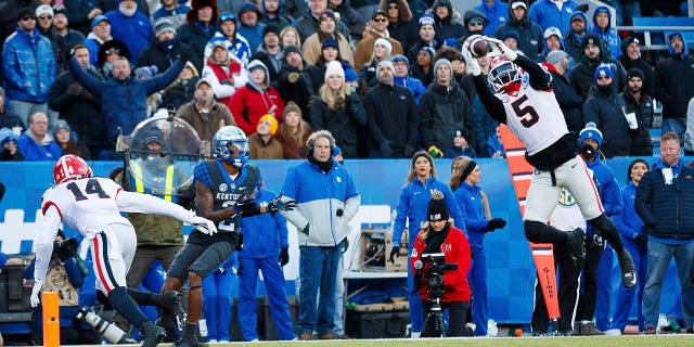 Georgia defensive back Kelee Ringo (5) intercepts a pass intended for Kentucky wide receiver Barion Brown (2) during the first half of a game in Lexington, Ky. on Saturday, November 19, 2022.