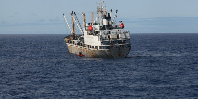 Guardsmen from the cutter James conduct a boarding of a fishing vessel in the eastern Pacific Ocean, on Aug. 3, 2022. (Petty Officer 3rd Class Hunter Schnabel/U.S. Coast Guard via AP)