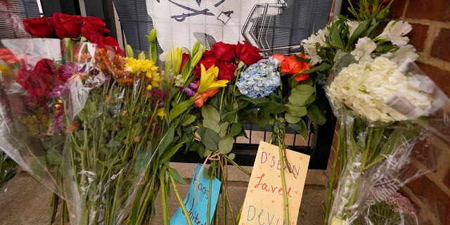 Memorial flowers and notes line walkway at Scott Stadium after three football players were killed in a shooting on the grounds of the University of Virginia Tuesday Nov. 15, 2022, in Charlottesville. Virginia.