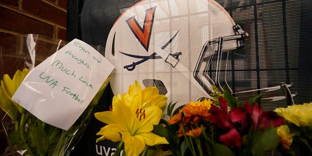 Memorial flowers and notes line walkway at Scott Stadium after three football players were killed in a shooting on the grounds of the University of Virginia Tuesday Nov. 15, 2022, in Charlottesville. 