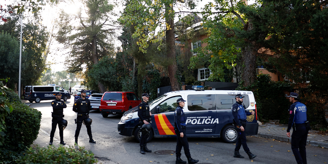 Police stand outside the Ukrainian embassy in Madrid following an explosion there Wednesday.