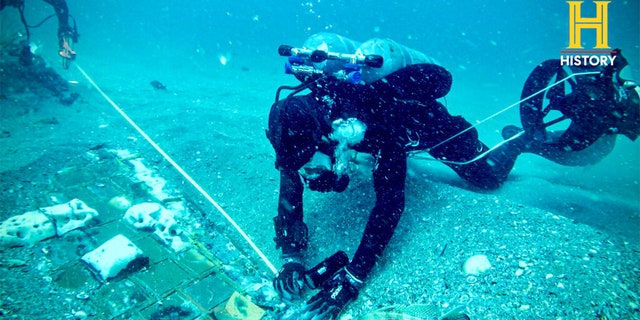 In this photo provided by the HISTORY® Channel, underwater explorer and marine biologist Mike Barnette and wreck diver Jimmy Gadomski explore a 20-foot segment of the 1986 Space Shuttle Challenger that the team discovered in the waters off the coast of Florida during the filming of The HISTORY® Channel’s new series, "The Bermuda Triangle: Into Cursed Waters," premiering Tuesday, Nov. 22, 2022. 