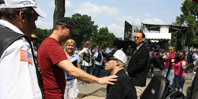 Travis Mills meeting Gary Sinise for the first time in May 2012 after returning home to recover at Walter Reed Military Medical Center. 