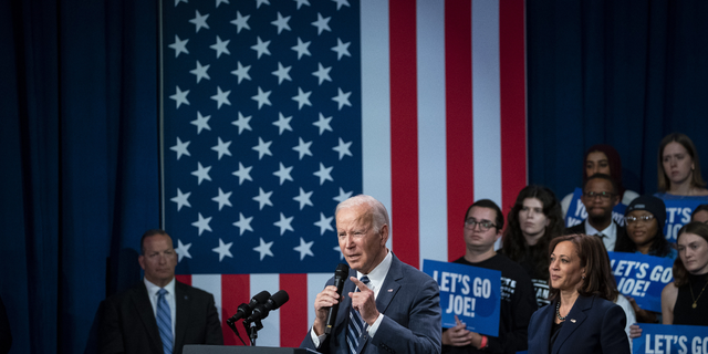 S President Joe Biden speaks as US Vice President Kamala Harris, right, listens during a Democratic National Committee (DNC) rally at Howard Theater in Washington, D.C.