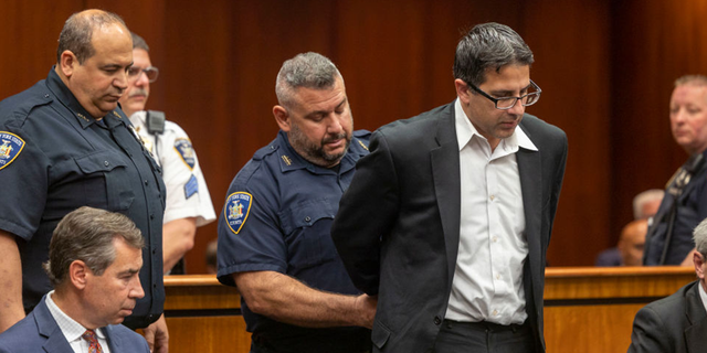 Former NYPD officer Michael Valva is handcuffed after the guilty verdict was read during his trial at Suffolk Criminal Court in Riverhead, New York.