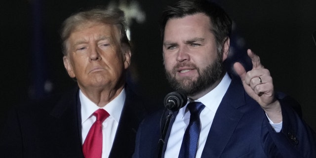Former President Donald Trump and Republican Senate candidate JD Vance greet supporters during a rally at Dayton International Airport in Vandalia, Ohio.