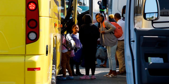 Venezuelan migrants board buss at Marthas Vineyard, Massachusetts.