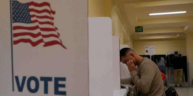 A man fills out his midterm ballot on Nov. 8, 2022. 