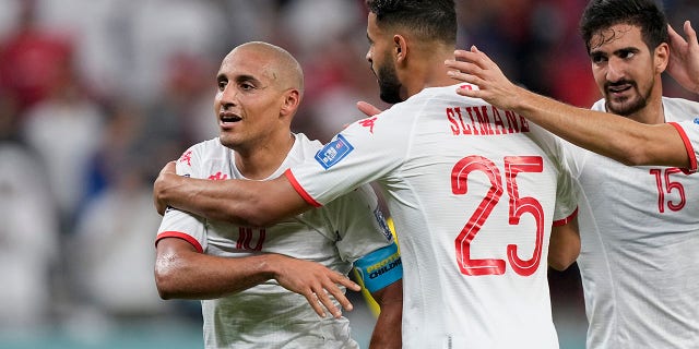 Teammaes congratulates Wahbi Khazri after he scored his team's first goal against France during a World Cup Group D soccer match at Education City Stadium in Al Rayyan, Qatar on Wednesday, November 30, 2022. 