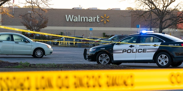 Law enforcement work the scene of a mass shooting at a Walmart, Wednesday, Nov. 23, 2022, in Chesapeake, Virginia.  The store was busy just before the shooting Tuesday night with people stocking up ahead of the Thanksgiving holiday. 