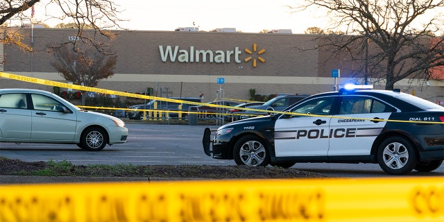 Law enforcement work the scene of a mass shooting at a Walmart, Wednesday, Nov. 23, 2022, in Chesapeake, Virginia.  The store was busy just before the shooting Tuesday night with people stocking up ahead of the Thanksgiving holiday. 