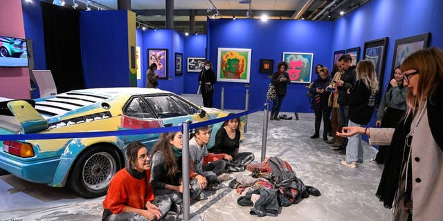 Climate-change activists from Ultima Generazione, or Last Generation, turned to Andy Warhol's painted BMW in Milan on Friday, Nov. 18, 2022, covering it with flour.