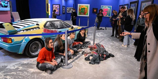 Climate change activists from Ultima Generazione, or The Last Generation, reached out to Andy Warhol's painted BMW in Milan on Friday, dusting it with flour.